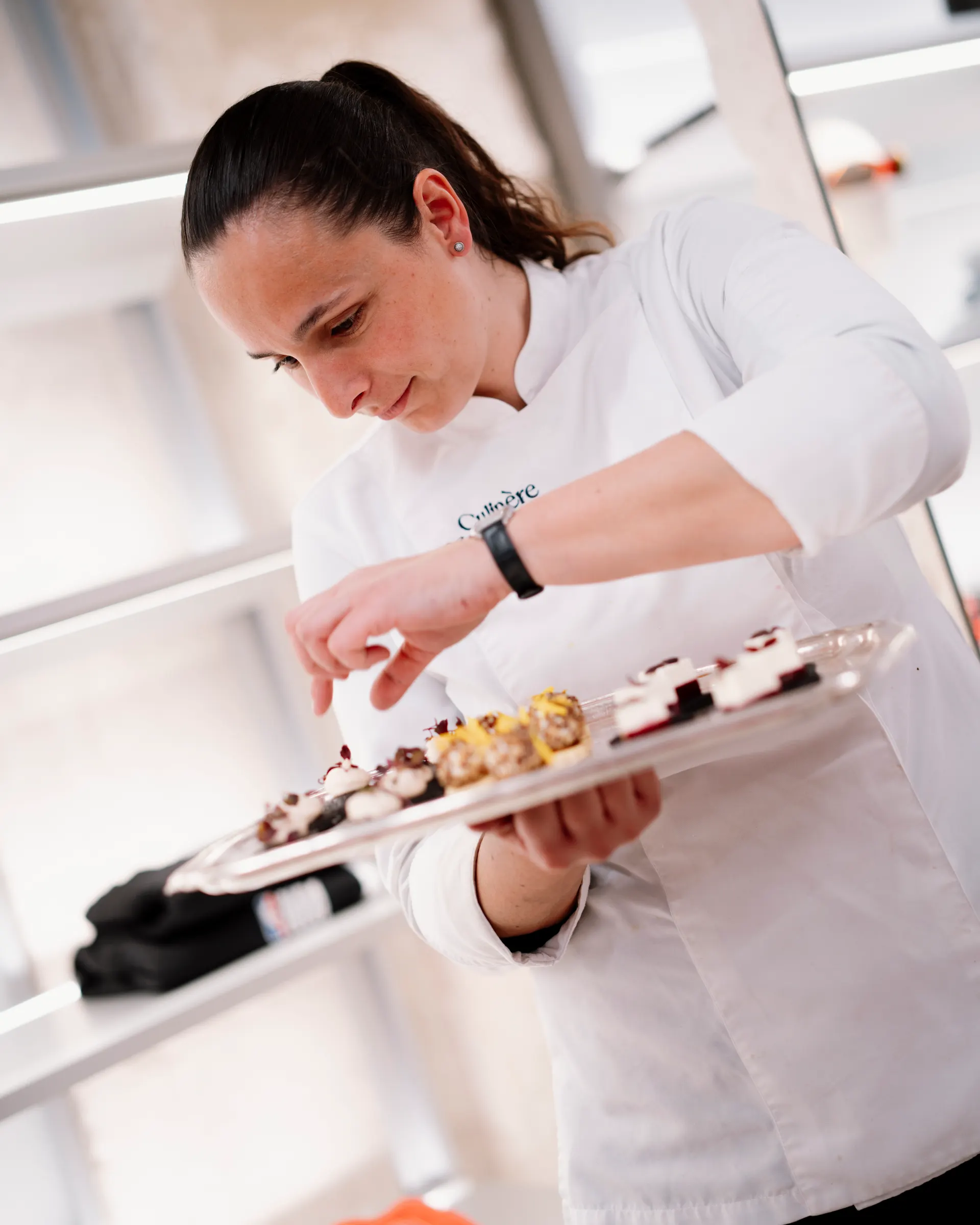 Anissa Boulesteix presenting a platter of canapés for a reception