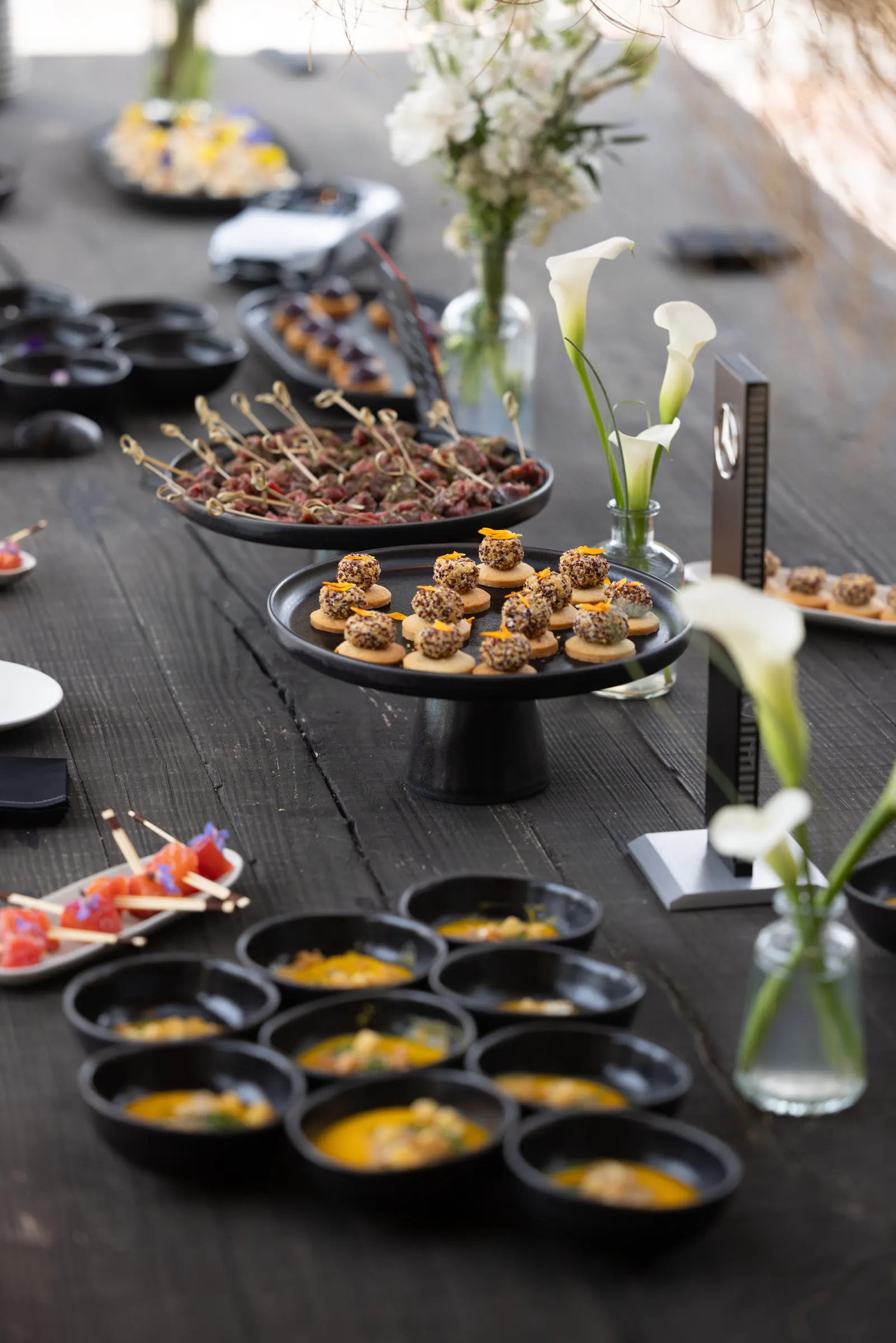 Catering buffet with platters and lilies for a reception